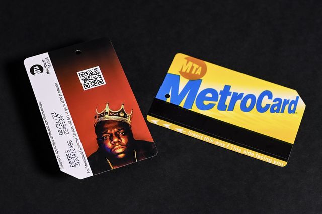 An image showing the back of a Metrocard with the Notorious B.I.G. wearing a crown against a red background. with a QR code, next to a Metrocard showing its yellow and blue front